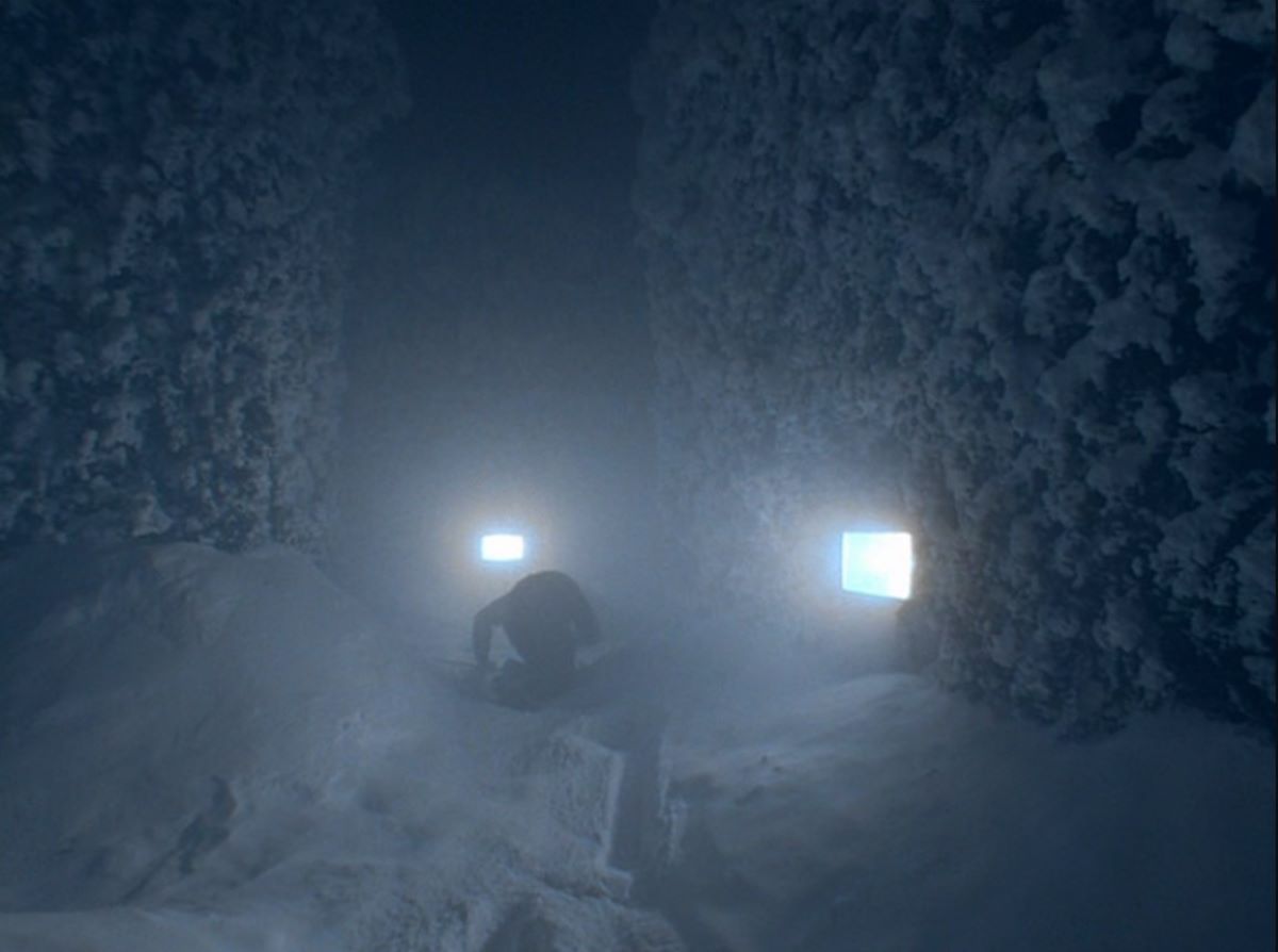 Image of a character from The Shining in the snow in the hedge maze with harsh white light on him. The Shining inspired the Until Dawn producers